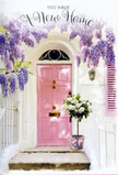 This image captures a Camden doorway transformed into a gentle celebration of new beginnings and quiet welcome. From the top of the frame, wisteria vines cascade downward in lush, dangling clusters of lavender and soft purple, their blossoms forming a loose curtain that softens the edges of the building. Each flower strand appears to sway slightly, as though stirred by the breeze that drifts along the nearby canal or across a peaceful square off Camden High Street. Beneath this floral canopy, a painted pink door stands at the centre, its hue a delicate blush that feels both playful and reassuring amid the whitewashed walls. A co-ordinating shutter, also softly painted, adds balance and draws the eye along the façade, enhancing the overall calm, pastel harmony. Just by the step, a vintage-style metal bucket is filled to overflowing with white and cream roses. The blooms look fresh and luxurious, their many petals opening generously to reveal subtle texture and depth. Soft green foliage threads between the flowers, providing contrast and echoing the natural greenery that pops up in Camden's hidden courtyards and communal gardens. Wrapped around the bucket's base is a pale pink ribbon, tied in a simple bow whose loose ends rest against the step like a quiet flourish of celebration. Gentle daylight washes over the entire arrangement, highlighting the curves of the petals and the panels of the door, and casting faint shadows that give the scene a softly layered feel. Together, the cascading wisteria, pastel doorway, and lush roses convey congratulations, comfort, and the heartfelt emotion of making a new place in Camden truly feel like home, whether for a first flat or a long-awaited move.